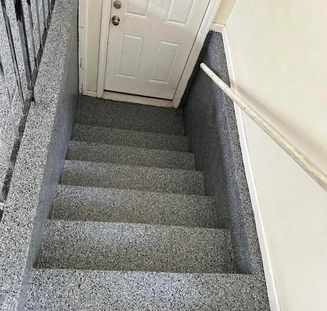 Gray flake epoxy coating on interior stairs
