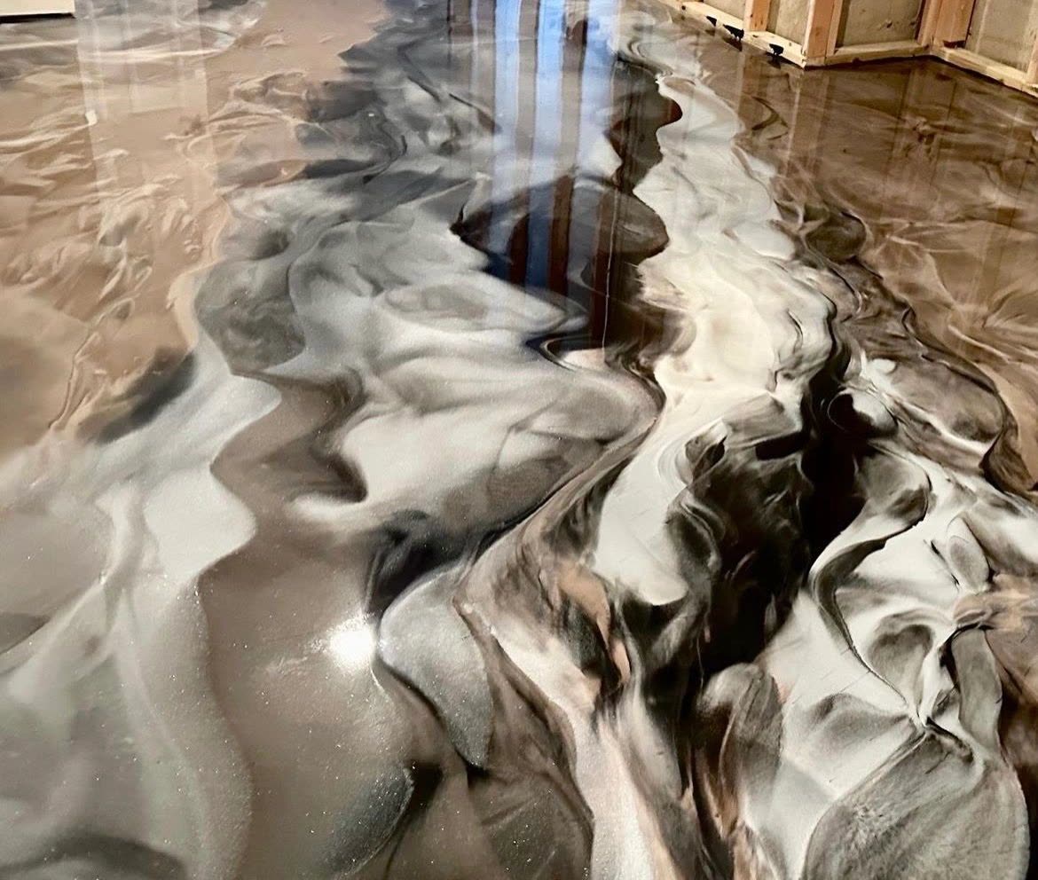 Metallic epoxy floor with black and silver marbled swirl finish, new construction