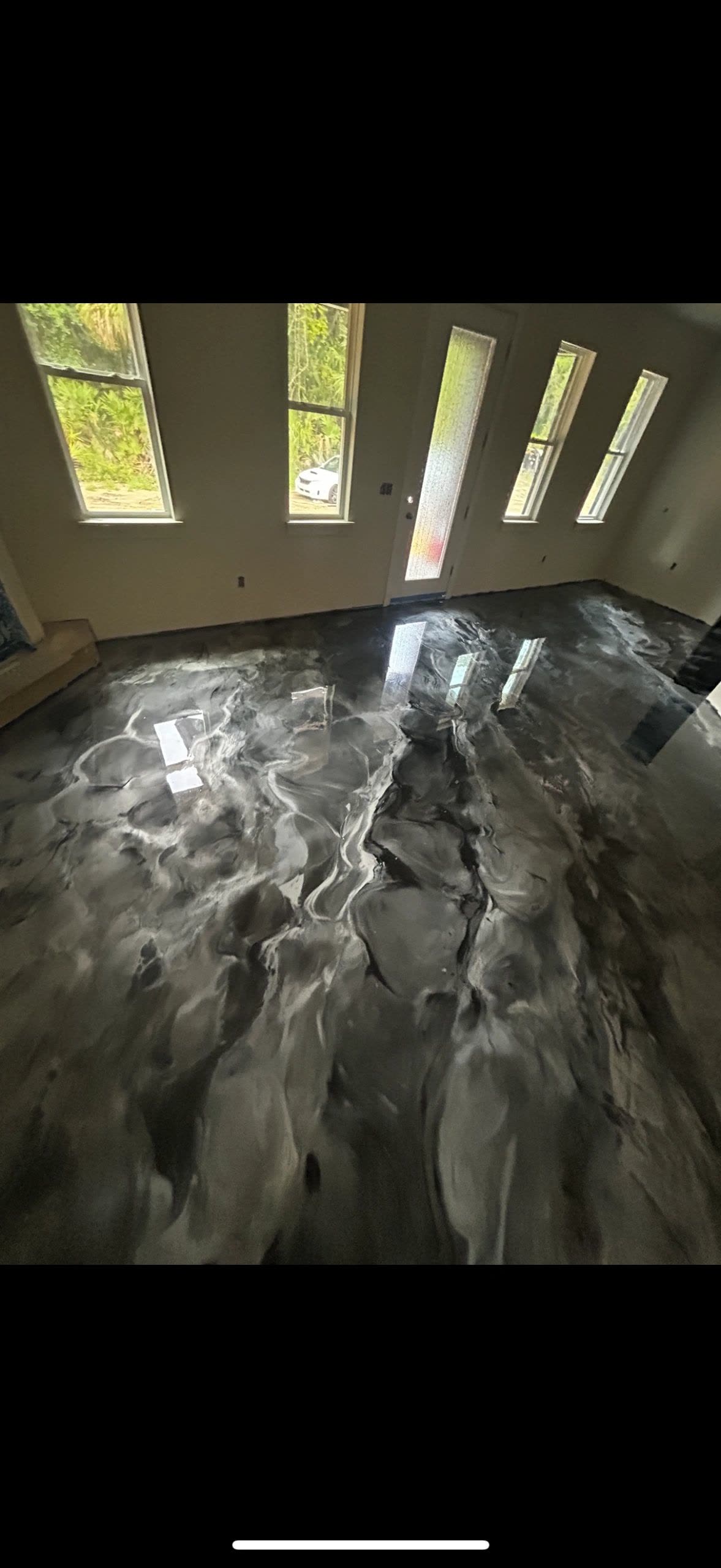 Dark charcoal metallic epoxy floor in a residential interior