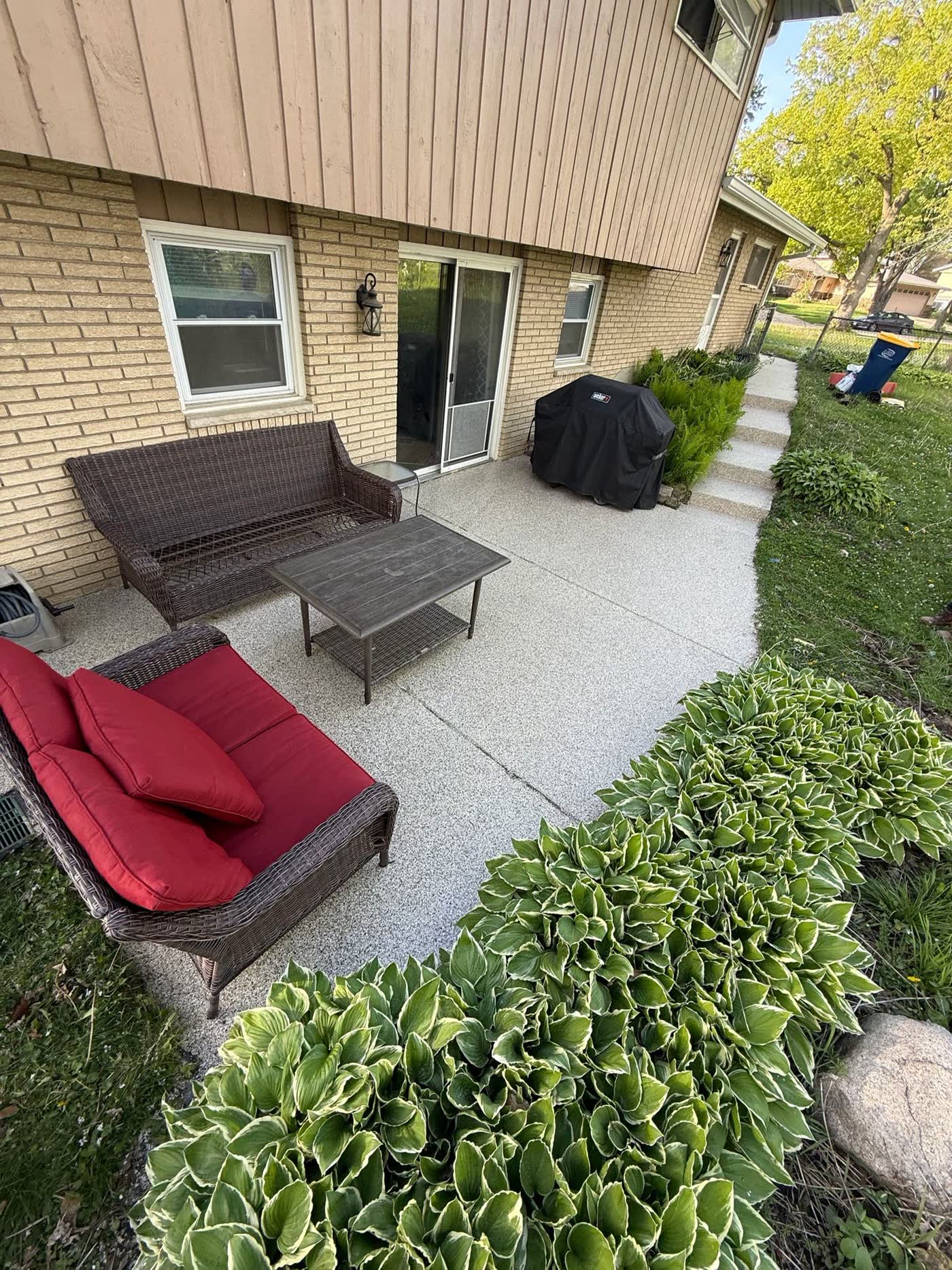 Flake epoxy coated backyard patio with outdoor furniture