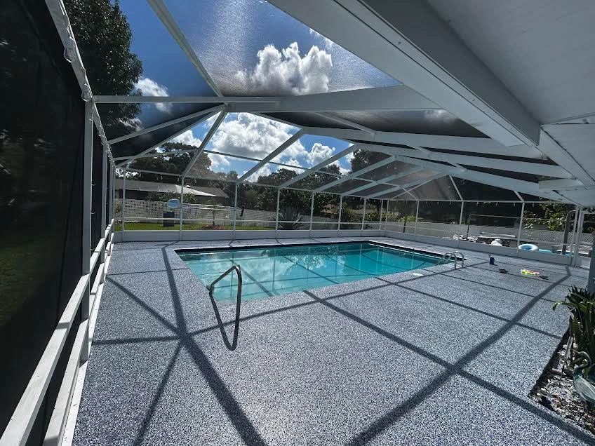 Flake epoxy coated pool deck under a screened enclosure